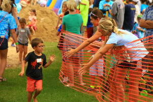 kid high fiving his family while running