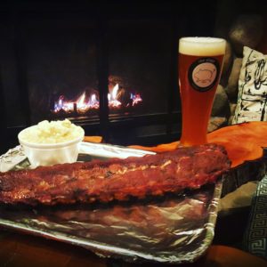 ribs mashed potatoes and a tall beer