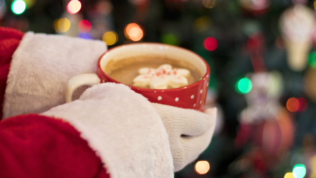 Santa holding a cup of cocoa