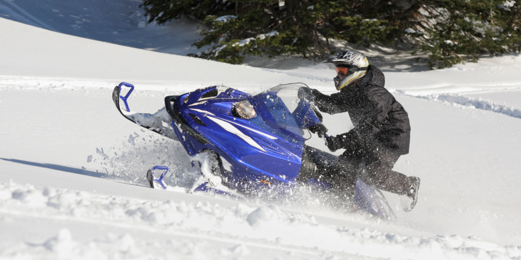 Man snowmobiling in winter
